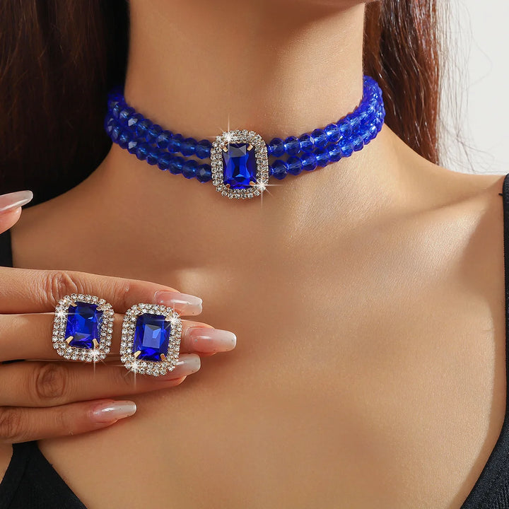 طقم عقد وأقراط مرصعة بالكريستال للنساء - مجوهرات للحفلات